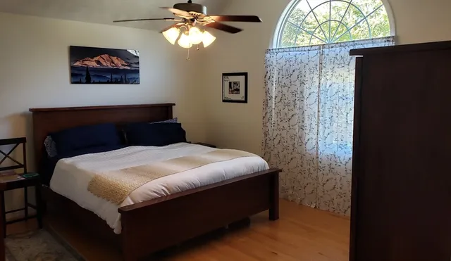 a bedroom with a bed and a chandelier