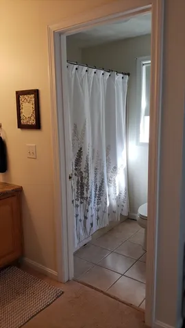 a view of a bathroom with a shower and a sink