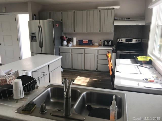 291 Potter Road Lancaster, SC 29720 - Photo 17 of 31 a kitchen with stainless steel appliances sink refrigerator and stove