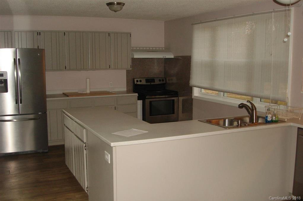 291 Potter Road Lancaster, SC 29720 - Photo 4 of 31 a kitchen with stainless steel appliances a refrigerator and a sink