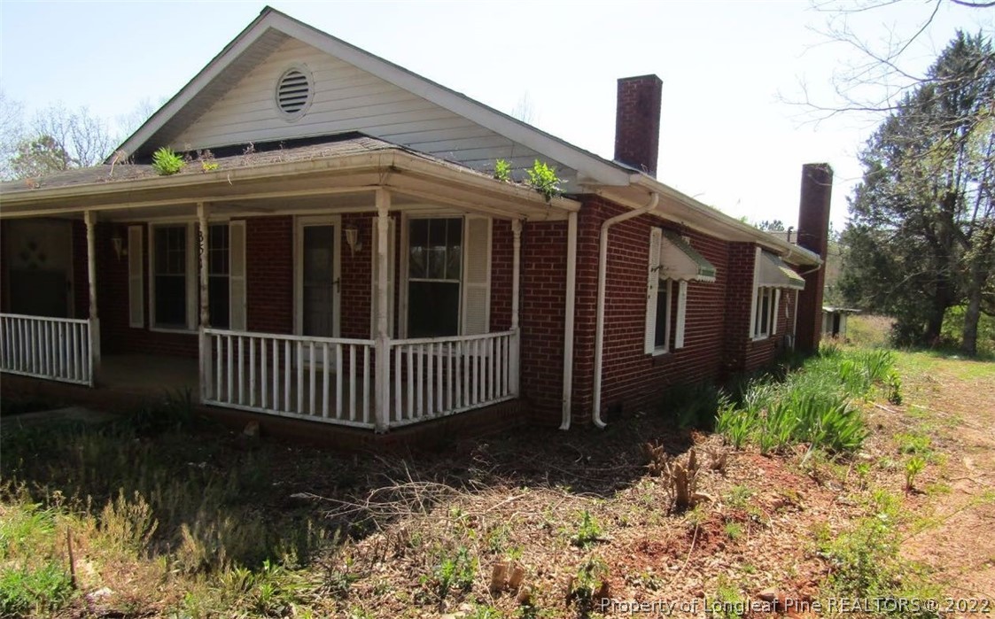 351 Lake Road Rockingham, NC 28379 - Photo 3 of 17 a front view of a house with a garden