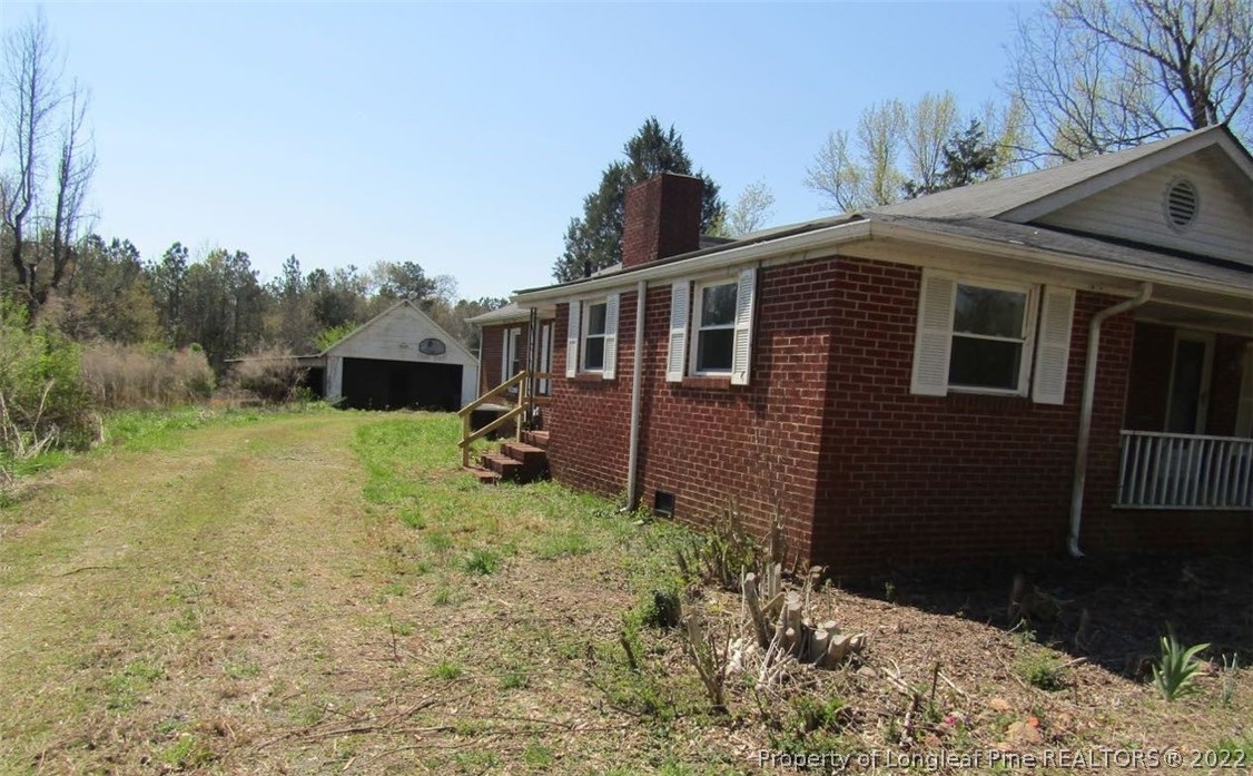 351 Lake Road Rockingham, NC 28379 - Photo 4 of 17 a view of a house with backyard and trees