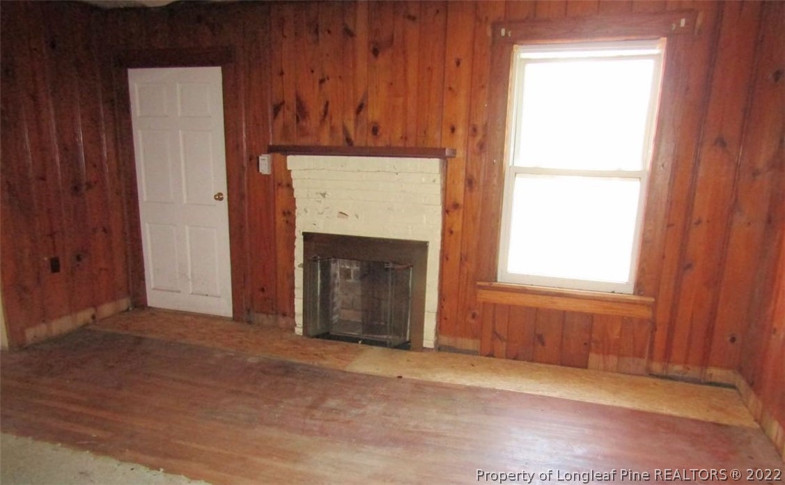 351 Lake Road Rockingham, NC 28379 - Photo 7 of 17 an empty room with windows and fireplace