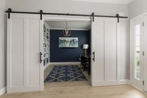 a living room with fish tank and a bookshelf