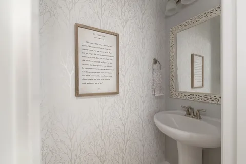 a living room with a large bed and a chandelier