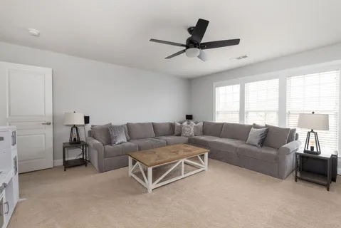 a spacious bathroom with a granite countertop sink a mirror and a shower