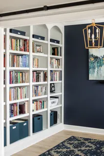 a view of a workspace with furniture and a book shelf