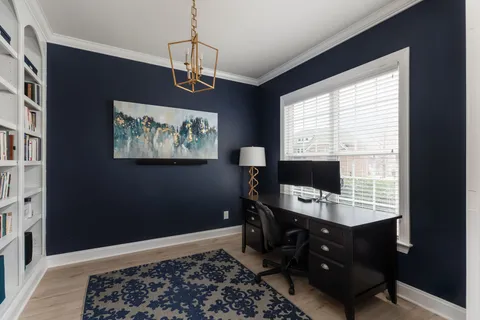 a dining room with furniture and wooden floor