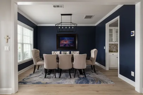 a view of a dining room with furniture and window