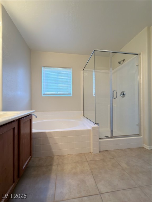 4650 Ranch House Road, Unit 95 North Las Vegas, NV 89031 - Photo 16 of 50 Bathroom featuring vanity, a bath, a shower stall, and light tile patterned floors