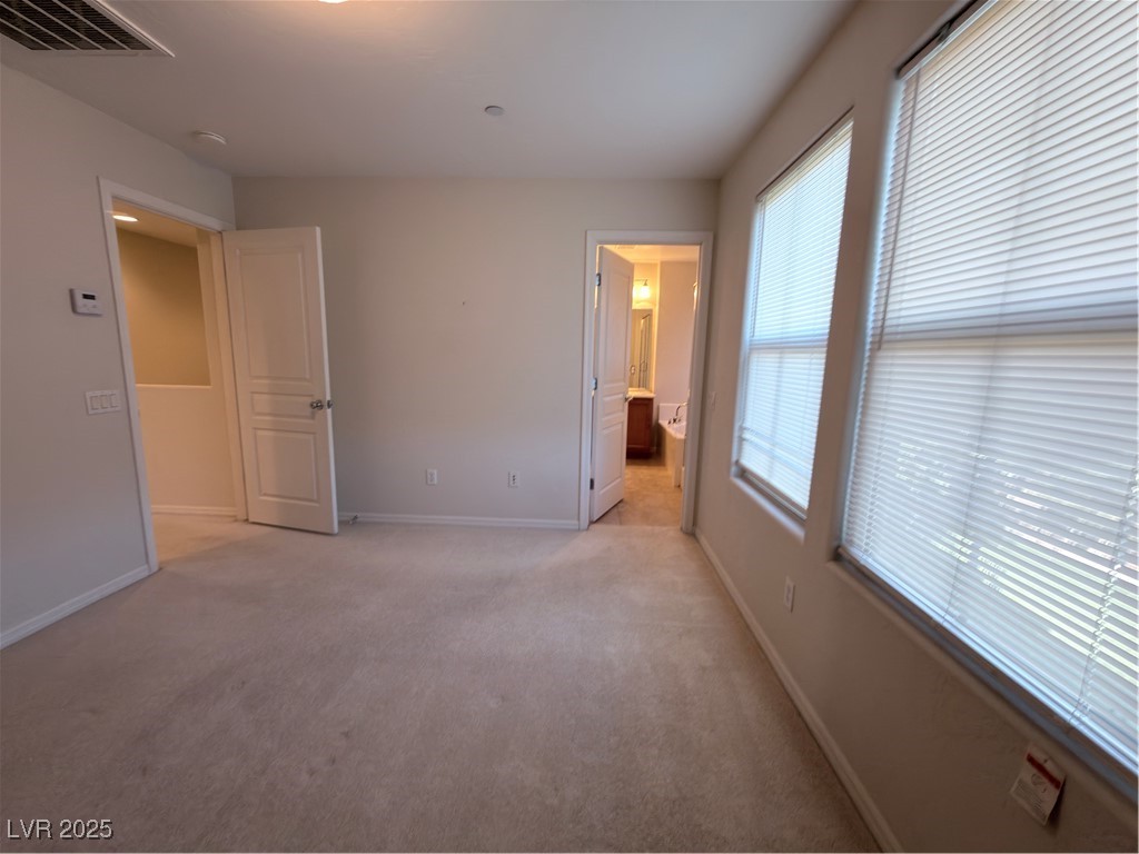 4650 Ranch House Road, Unit 95 North Las Vegas, NV 89031 - Photo 18 of 50 Unfurnished bedroom with light carpet and ensuite bathroom