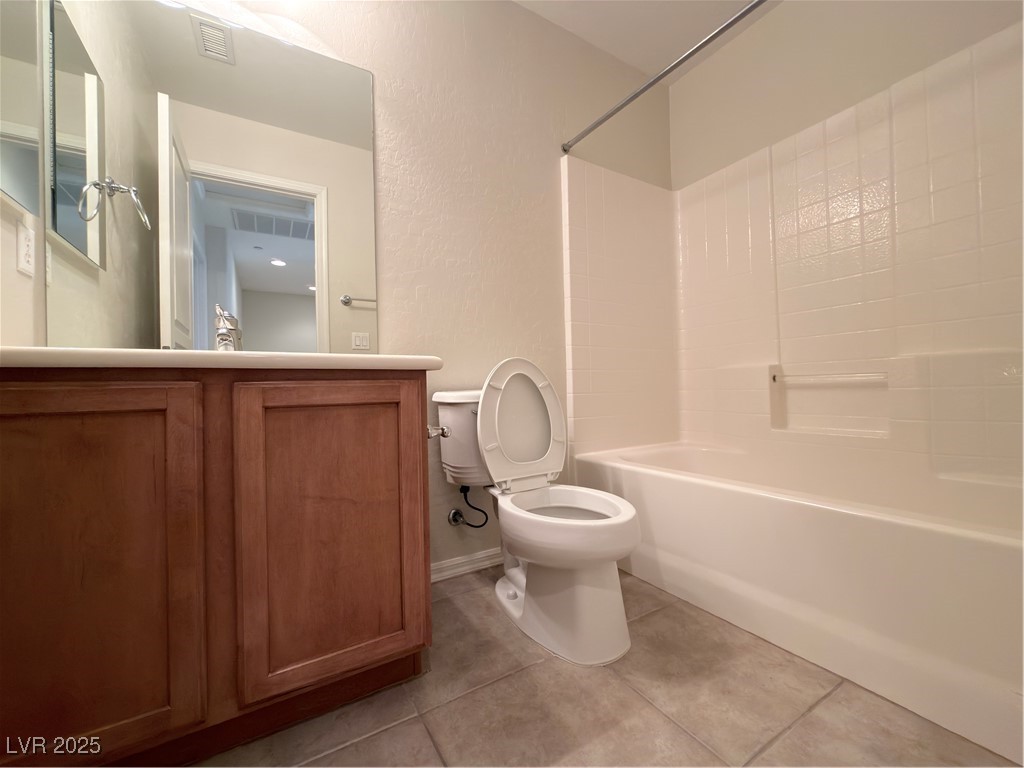 4650 Ranch House Road, Unit 95 North Las Vegas, NV 89031 - Photo 19 of 50 Bathroom featuring bathtub / shower combination, light tile patterned floors, vanity, and a textured wall