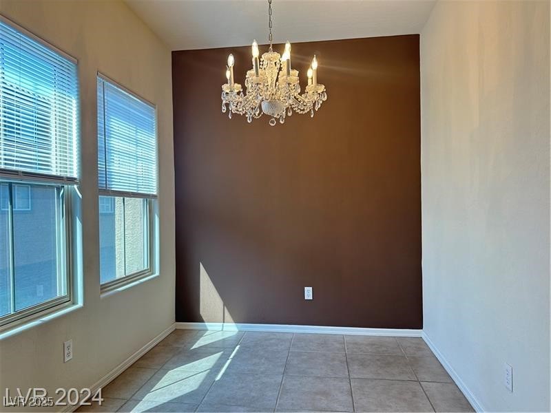 4650 Ranch House Road, Unit 95 North Las Vegas, NV 89031 - Photo 24 of 50 Spare room featuring healthy amount of natural light, light tile patterned floors, and a chandelier