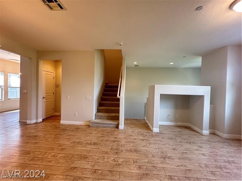 4650 Ranch House Road, Unit 95 North Las Vegas, NV 89031 - Photo 32 of 50 Unfurnished living room featuring light wood-style flooring and stairway