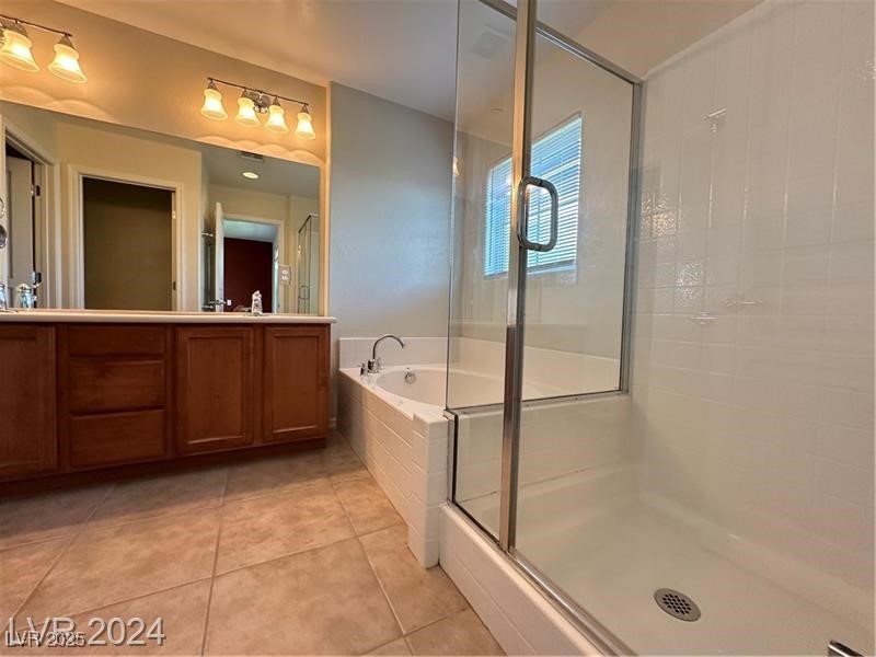 4650 Ranch House Road, Unit 95 North Las Vegas, NV 89031 - Photo 38 of 50 Bathroom featuring double vanity, a bath, a shower stall, and light tile patterned floors