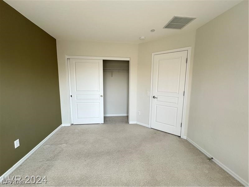 4650 Ranch House Road, Unit 95 North Las Vegas, NV 89031 - Photo 40 of 50 Unfurnished bedroom with light colored carpet and a closet