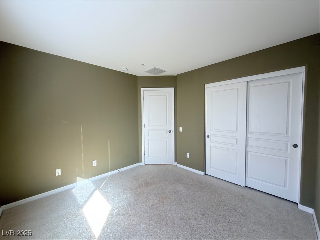 4650 Ranch House Road, Unit 95 North Las Vegas, NV 89031 - Photo 10 of 50 Unfurnished bedroom featuring carpet and a closet
