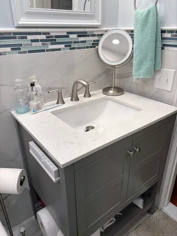 a bathroom with a toilet and a mirror