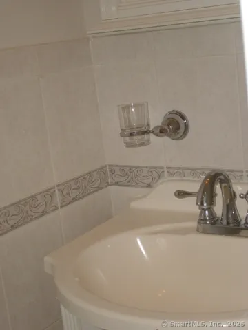 an empty room with wooden floor and white walls