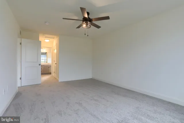 a view of a livingroom with a ceiling fan and window