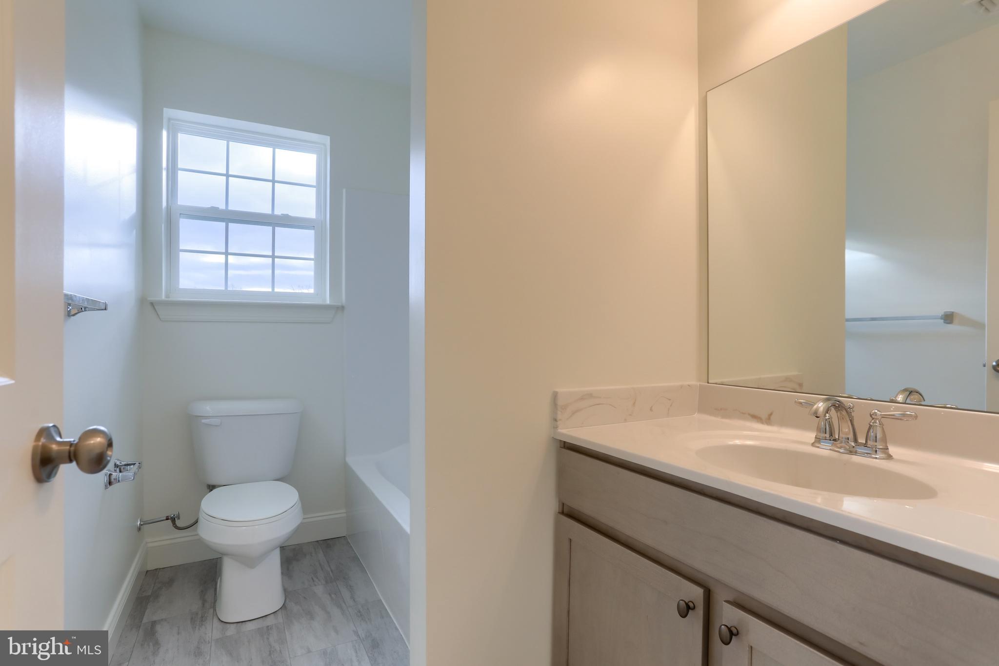 0 Lavender Lane Lebanon, PA 17042 - Photo 19 of 23 a bathroom with a toilet a sink and mirror