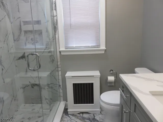a bathroom with a toilet and a shower
