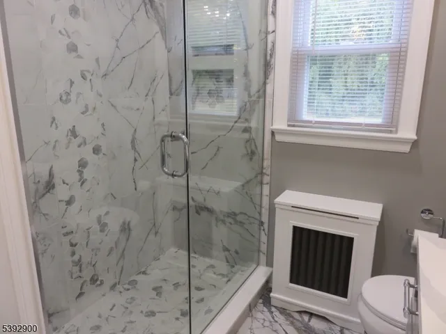 a bathroom with a sink toilet and a mirror