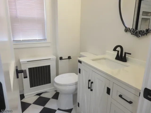 a bathroom with a sink a toilet and a mirror