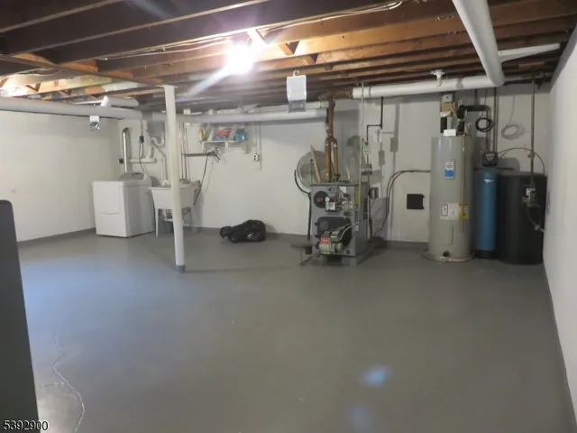 a view of a house with pool and trees in the background