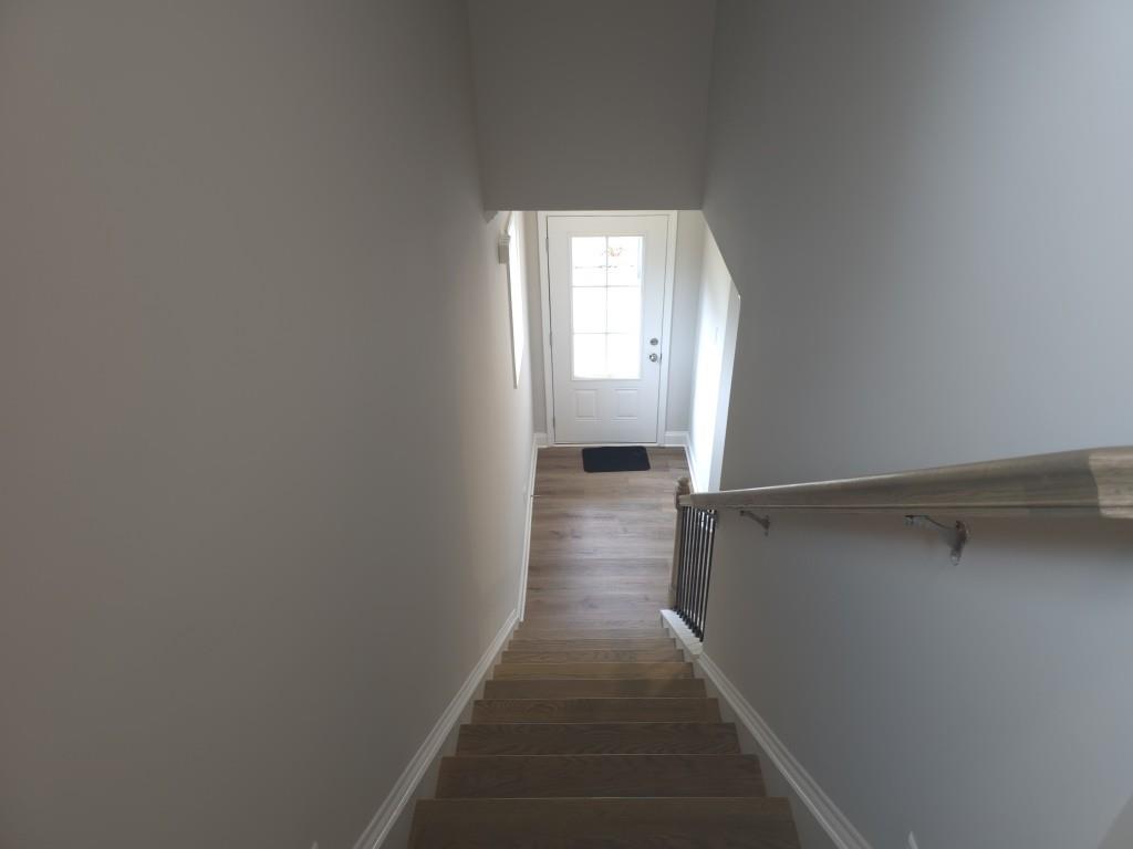 4240 Cavalier Way Duluth, GA 30097 - Photo 16 of 46 a view of a hallway with wooden floor and staircase