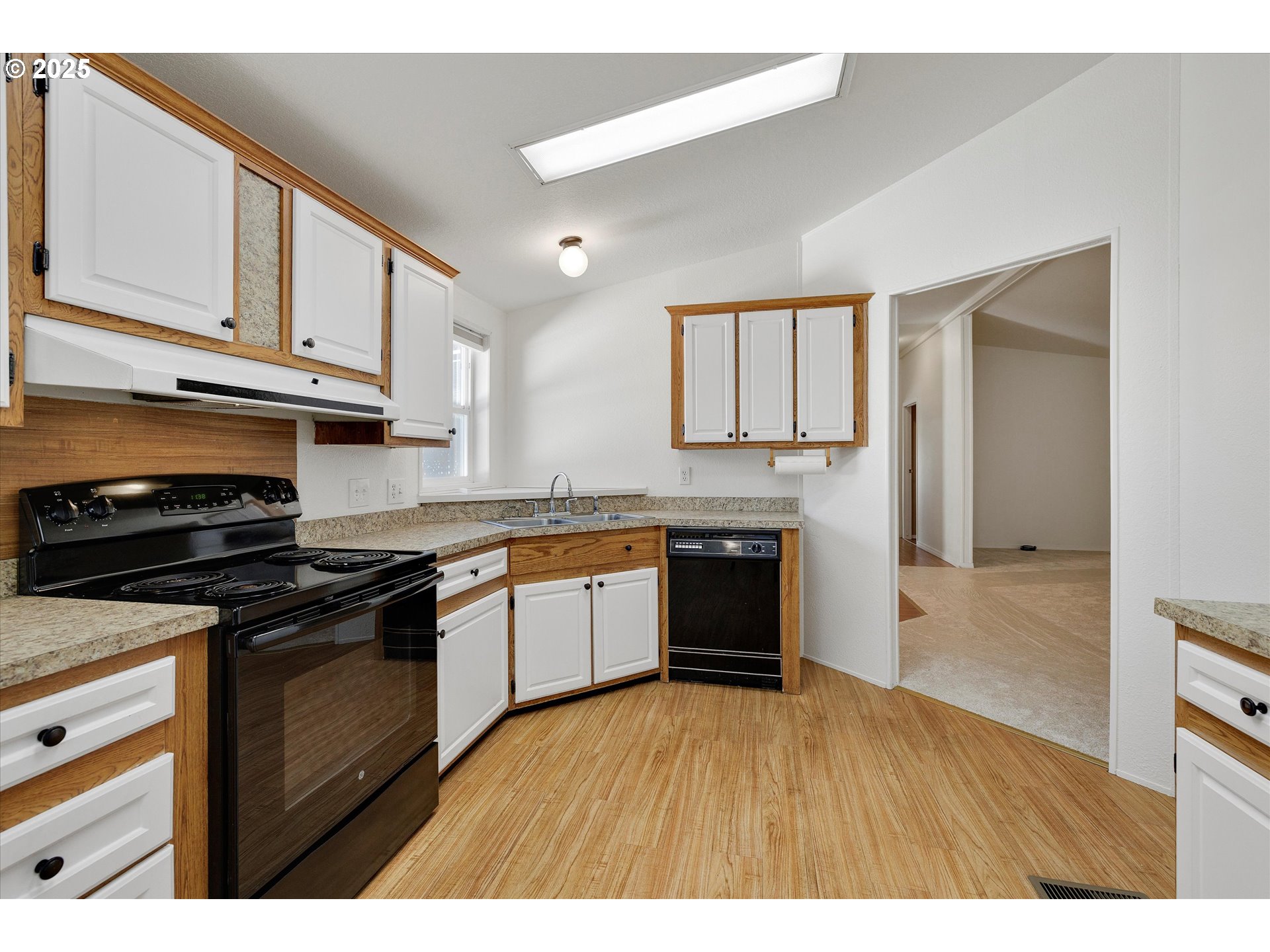 507 North 19th Avenue, Unit 60 Cornelius, OR 97113 - Photo 11 of 28 a kitchen with granite countertop a stove top oven and cabinets