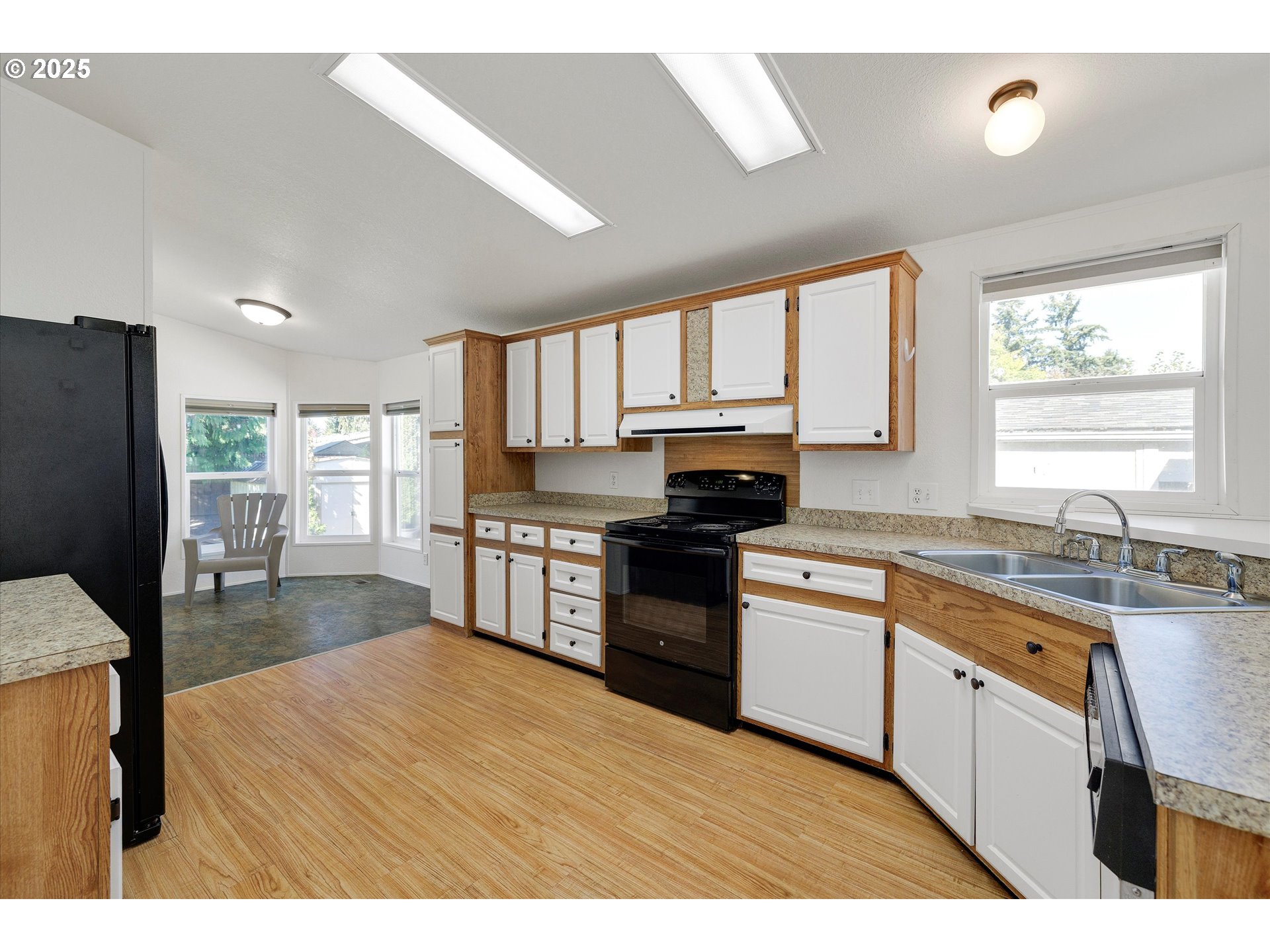 507 North 19th Avenue, Unit 60 Cornelius, OR 97113 - Photo 9 of 28 a kitchen with stainless steel appliances granite countertop a refrigerator a sink dishwasher a stove with wooden cabinets and floor