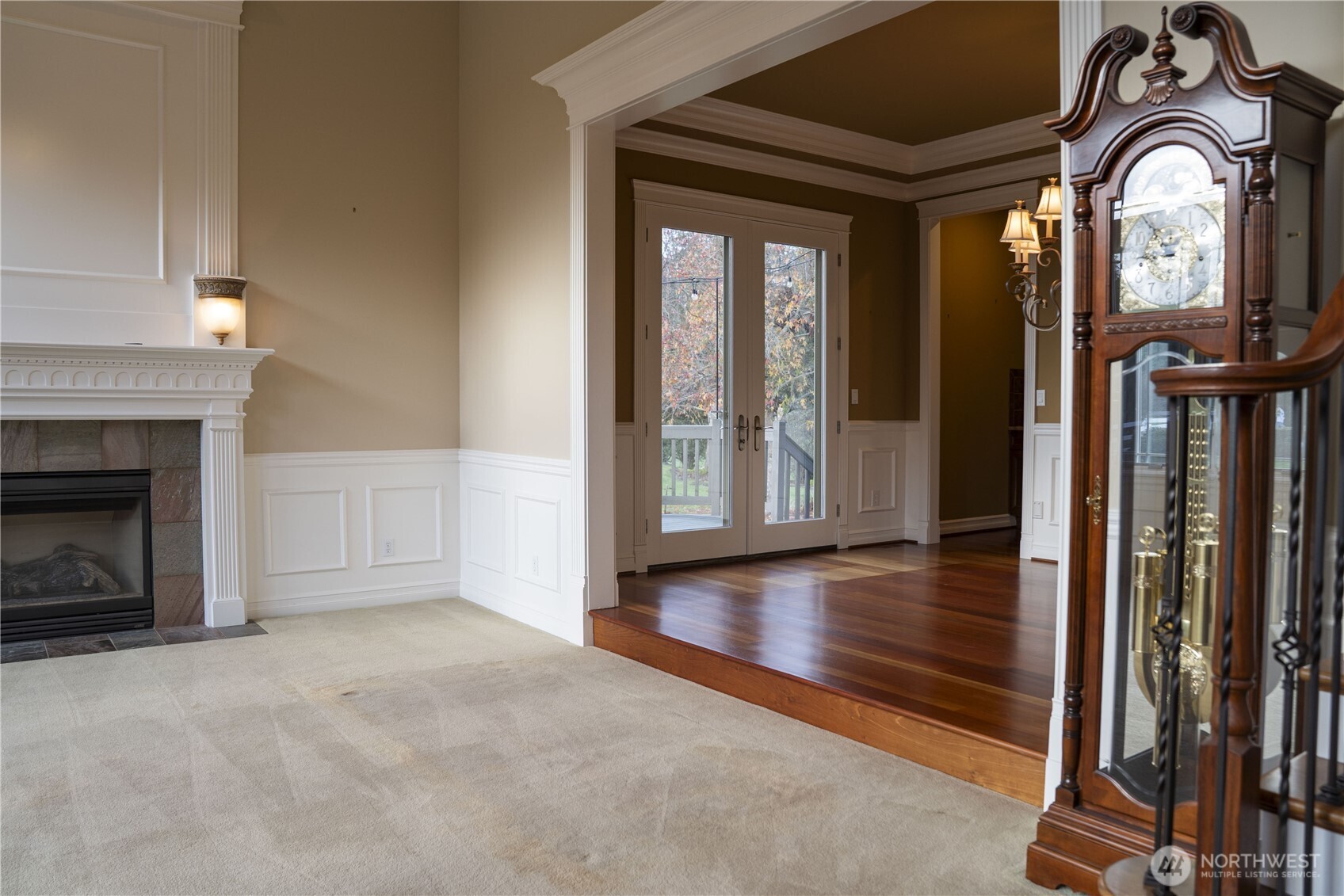 9701 148th Street Southeast Snohomish, WA 98296 - Photo 12 of 18 a view of a livingroom with a fireplace wooden floor and windows