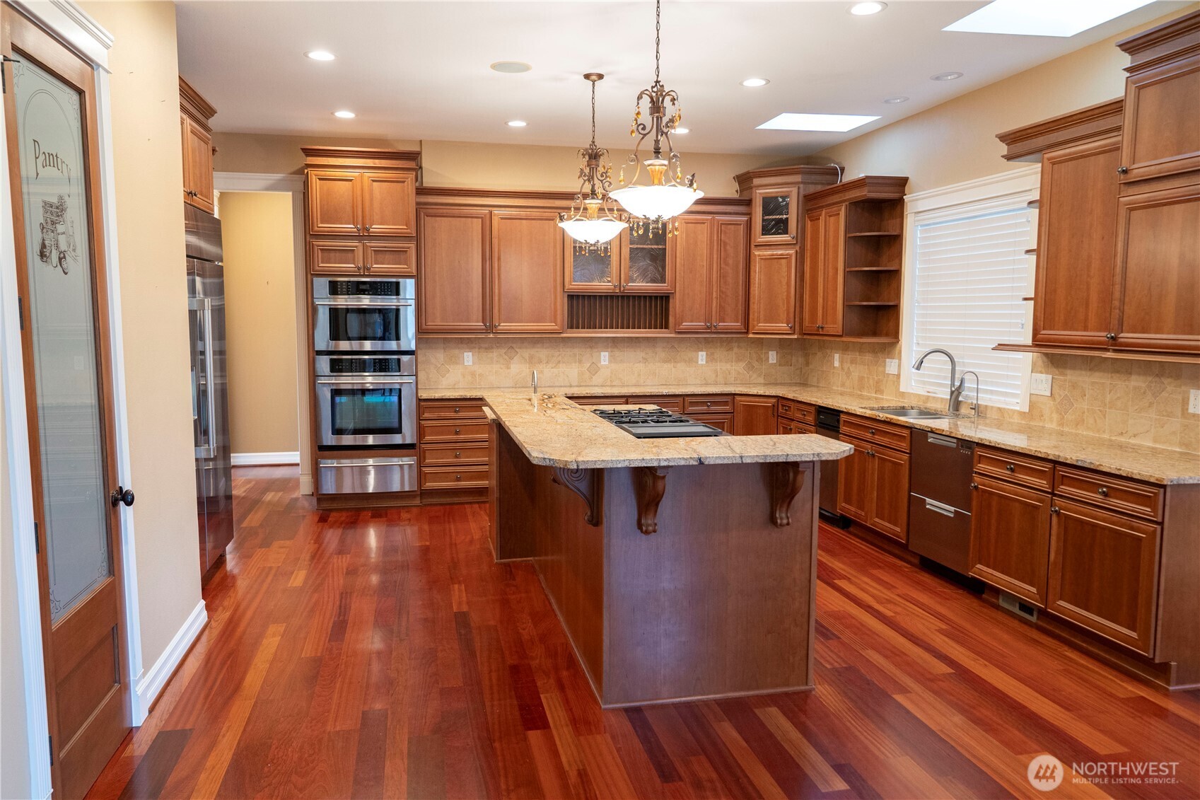 9701 148th Street Southeast Snohomish, WA 98296 - Photo 3 of 18 a kitchen with stainless steel appliances granite countertop a sink a stove and a wooden floors
