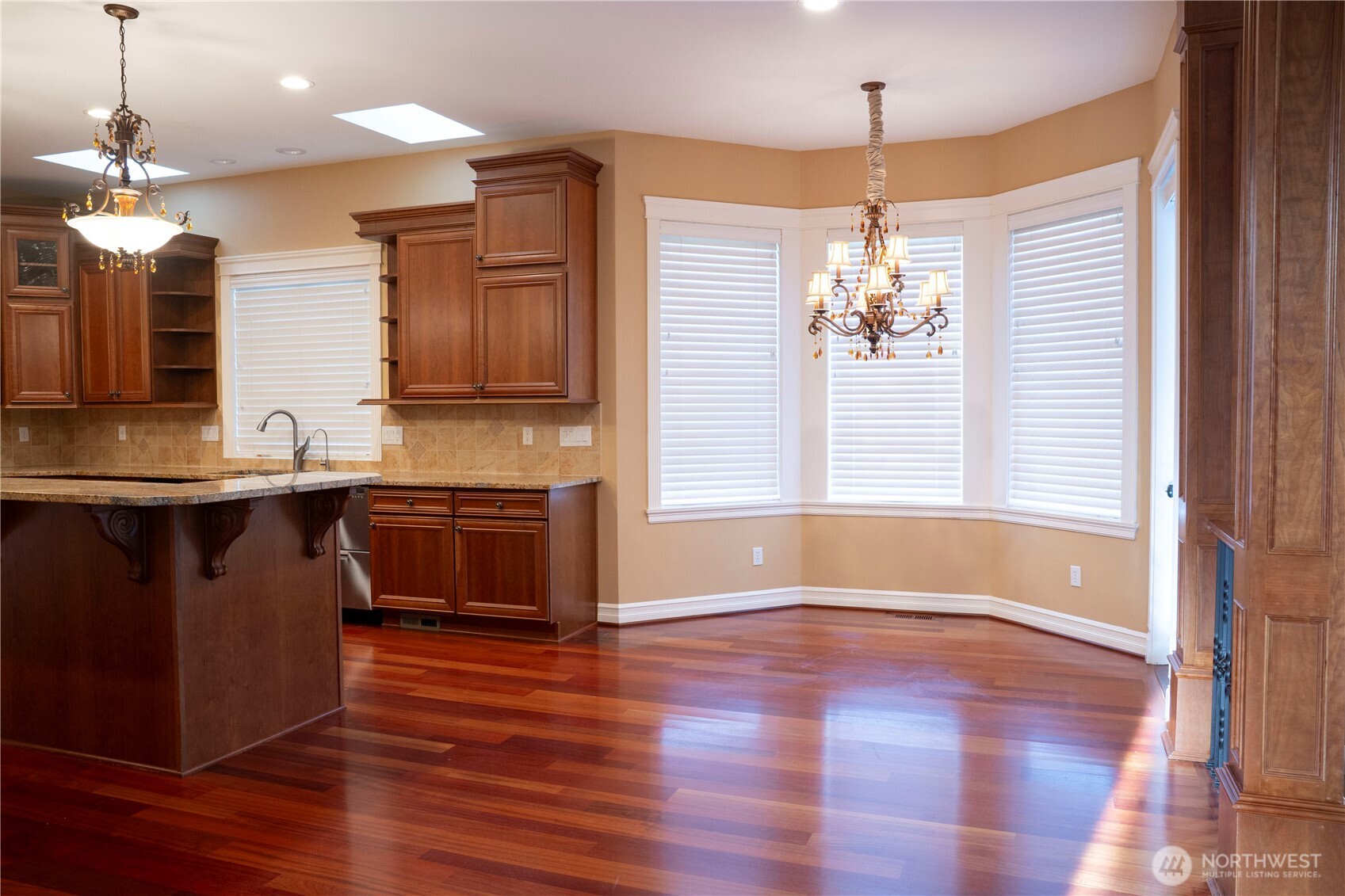 9701 148th Street Southeast Snohomish, WA 98296 - Photo 6 of 18 a spacious bathroom with a granite countertop sink a large mirror and a wooden floor