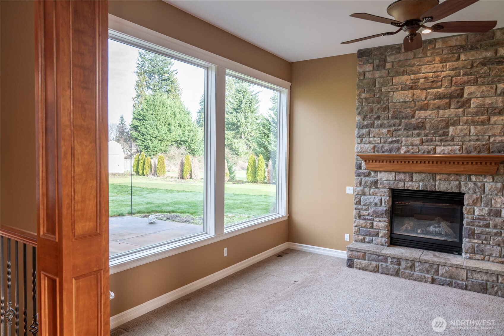 9701 148th Street Southeast Snohomish, WA 98296 - Photo 9 of 18 a living room with a fireplace and a floor to ceiling window