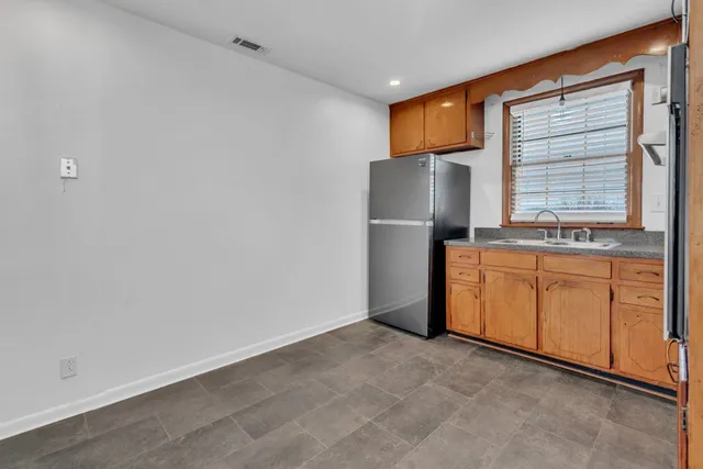a view of a room with wooden floor and windows