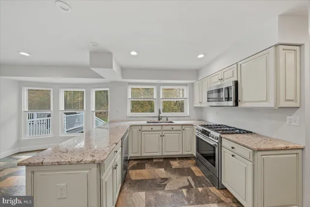 a kitchen with stainless steel appliances a refrigerator and cabinets