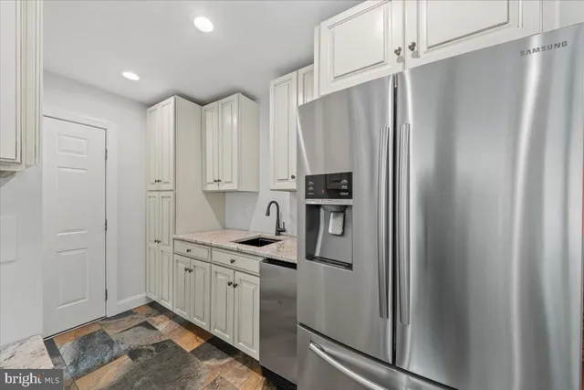 a view of a livingroom with wooden floor and furniture