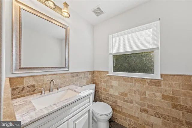 a living room with furniture flat screen tv and window