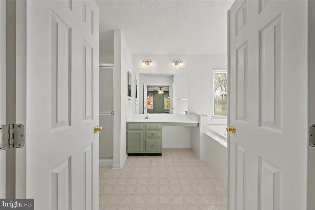 a bathroom with a double vanity sink and mirror