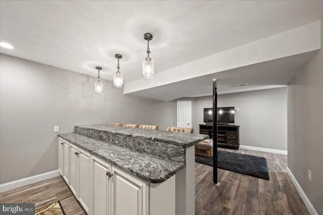 a view of a workspace with furniture and other items