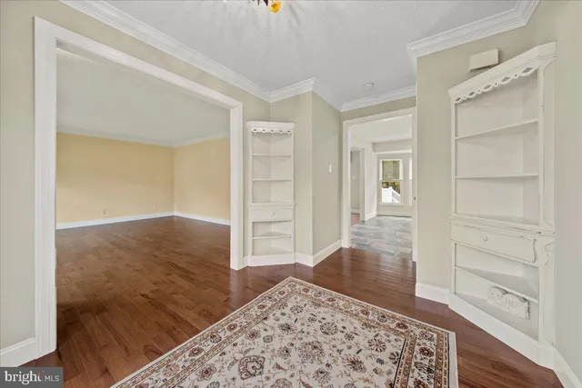 a view of a room with wooden floor and furniture