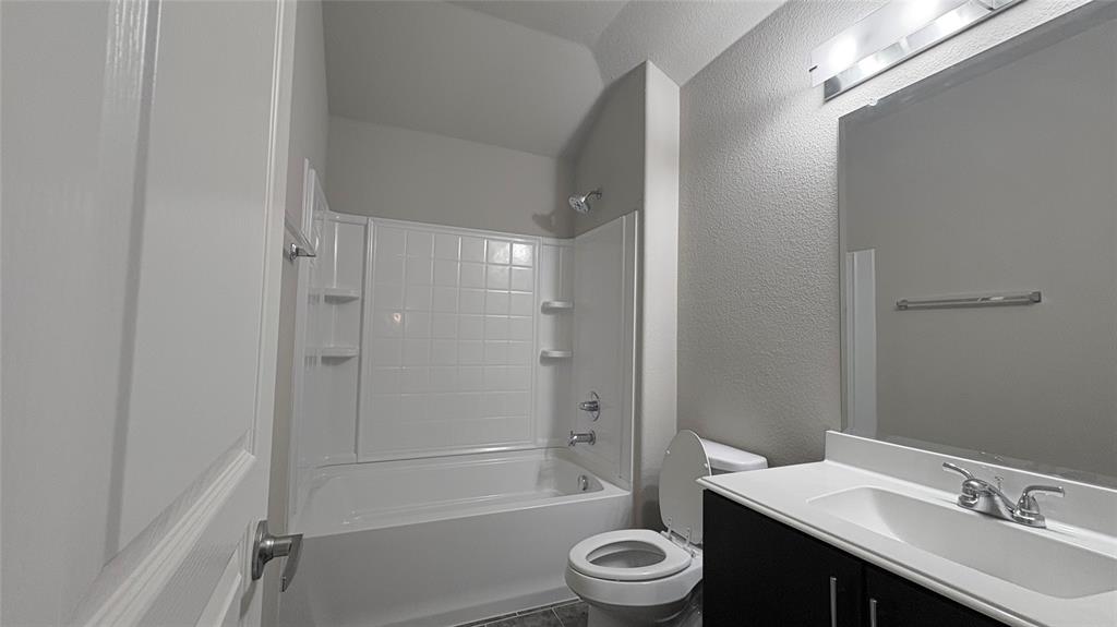 2101 Long Forest Road Forney, TX 75126 - Photo 12 of 15 a bathroom with a granite countertop sink toilet and shower