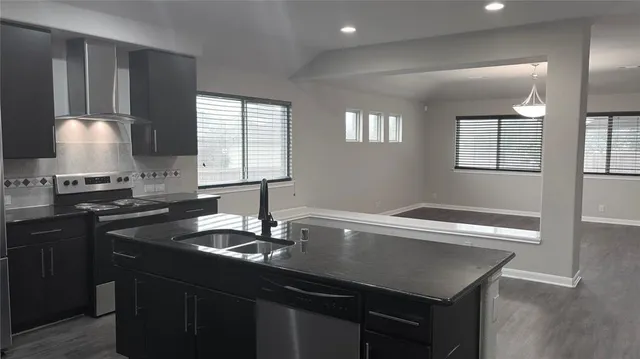 a kitchen with a sink cabinets and window
