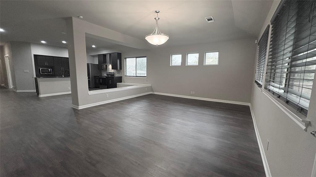 2101 Long Forest Road Forney, TX 75126 - Photo 5 of 15 an empty room with wooden floor and windows