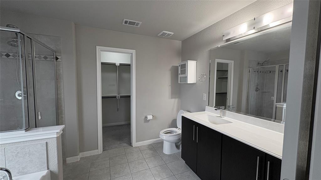 2101 Long Forest Road Forney, TX 75126 - Photo 10 of 15 a bathroom with a double vanity sink toilet and shower