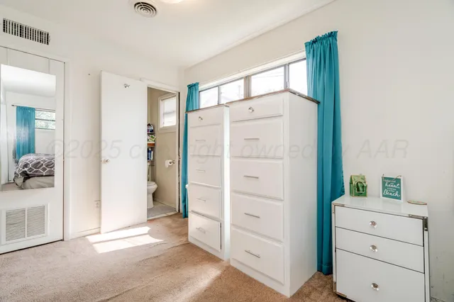 a view of a dresser with mirror in it