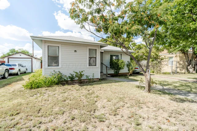 a view of a house with a tree in the background
