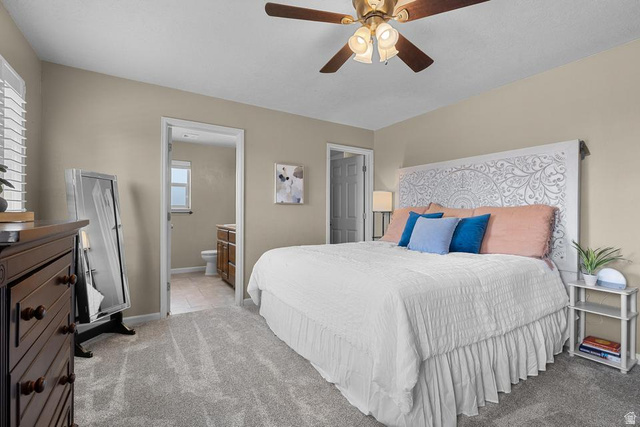 225 Falcon Court Ivins, UT 84738 - Photo 10 of 47 Bedroom featuring light carpet, a ceiling fan, and connected bathroom